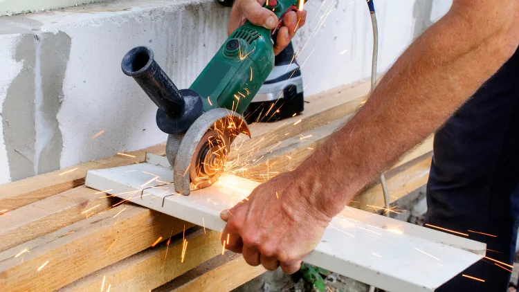 Cutting metal sheets with an angle grinder.